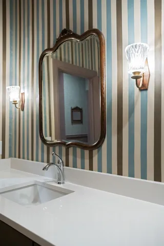 a bedroom with furniture and a large window