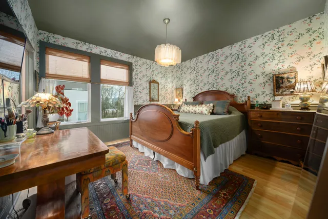 a bed room with a bed mirror and a desk