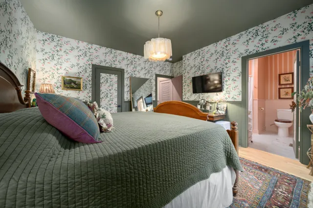 a kitchen with stainless steel appliances kitchen island granite countertop a sink and a white cabinets