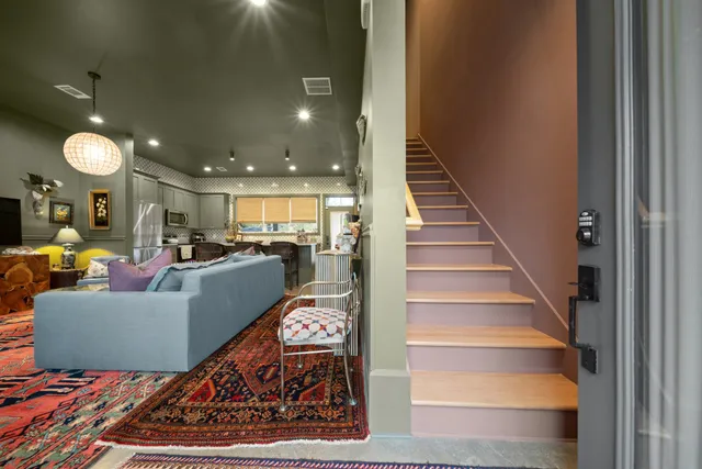 a living room with furniture and a chandelier