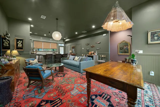 a living room with fireplace furniture and a chandelier