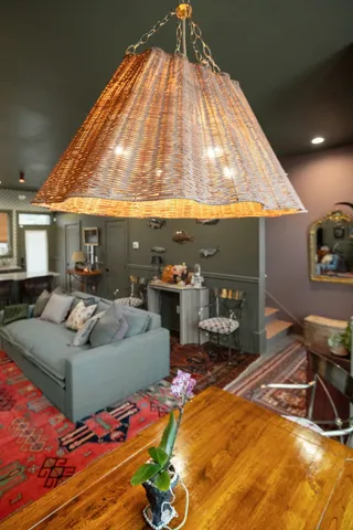 a living room with furniture a rug and white walls