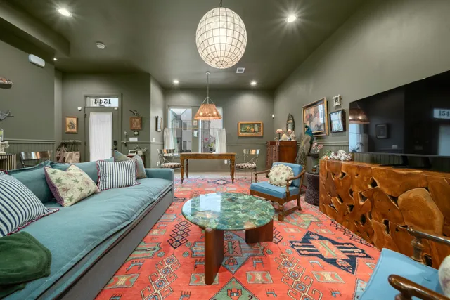 a living room with furniture a rug and a flat screen tv