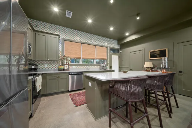 a kitchen with a table and chairs in it
