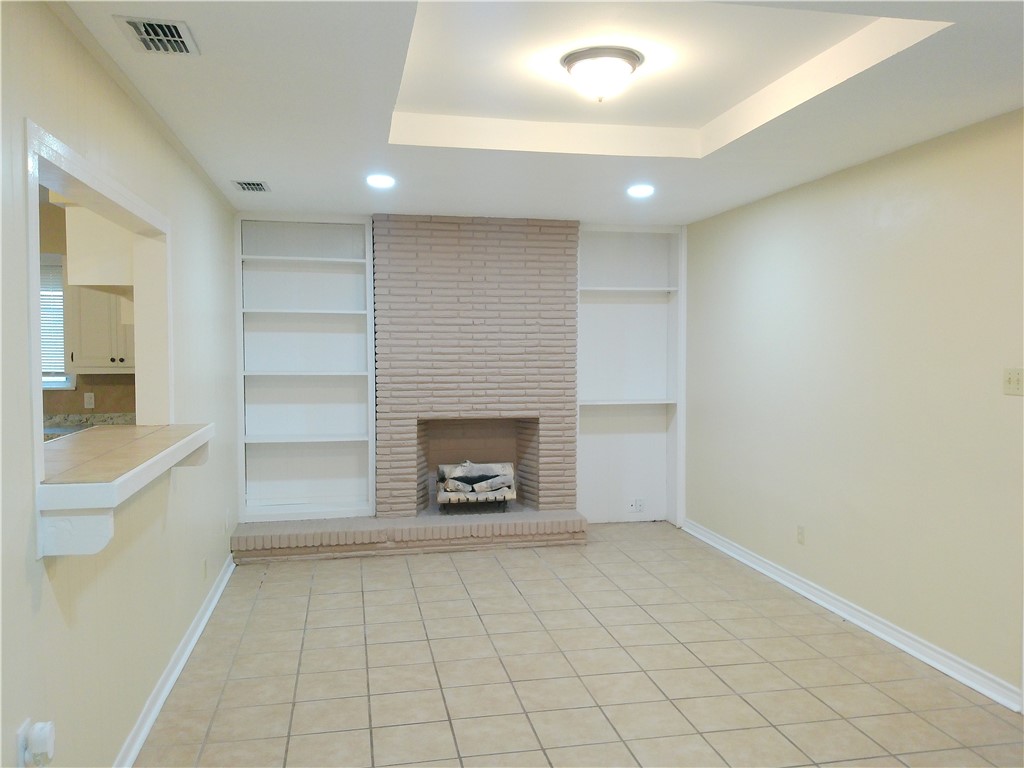 109 Sutherland Drive Portland, TX 78374 - Photo 3 of 17 an empty room with a fireplace and cabinet