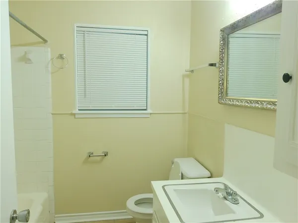a bathroom with a toilet sink and shower