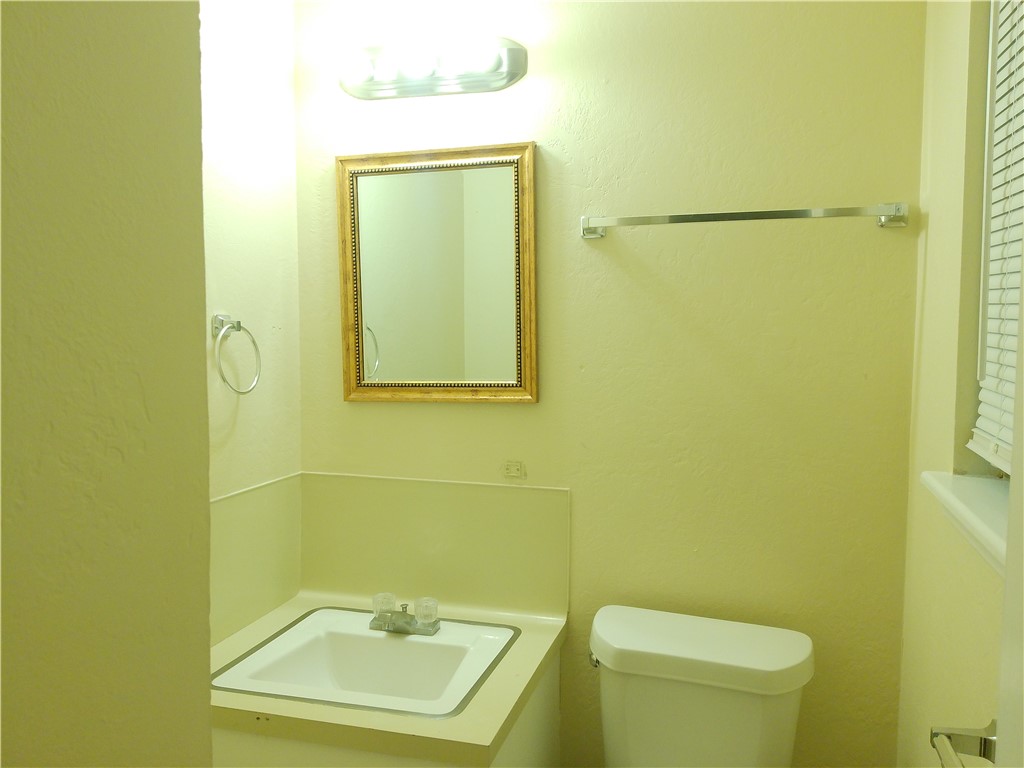 109 Sutherland Drive Portland, TX 78374 - Photo 8 of 17 a bathroom with a toilet sink and mirror
