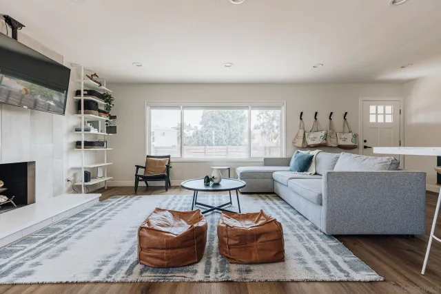 a living room with furniture a fireplace and a flat screen tv