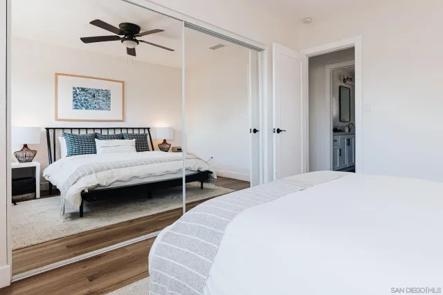 a large bed sitting in a bedroom next to a lamp