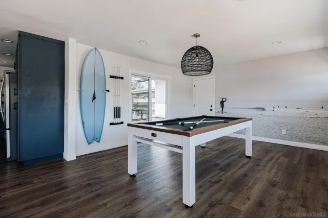 a kitchen with stainless steel appliances a refrigerator a sink and white cabinets