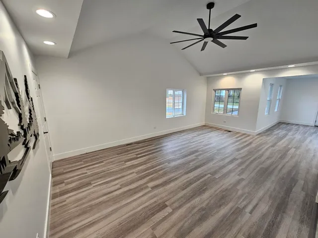 a kitchen with wooden floors and appliances