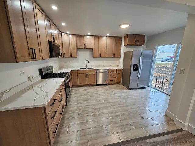 a view of a room with wooden floor