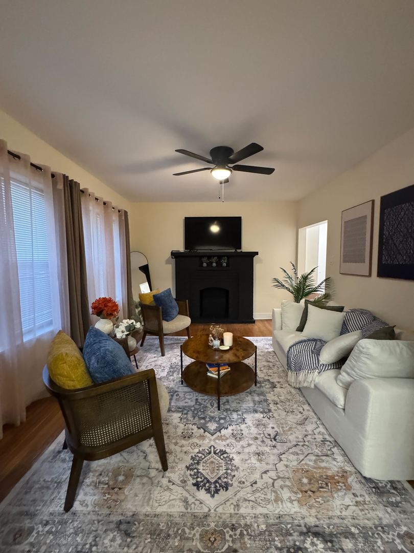610 East 74th Street, Unit 1B Chicago, IL 60619 - Photo 5 of 15 a living room with furniture and a fireplace