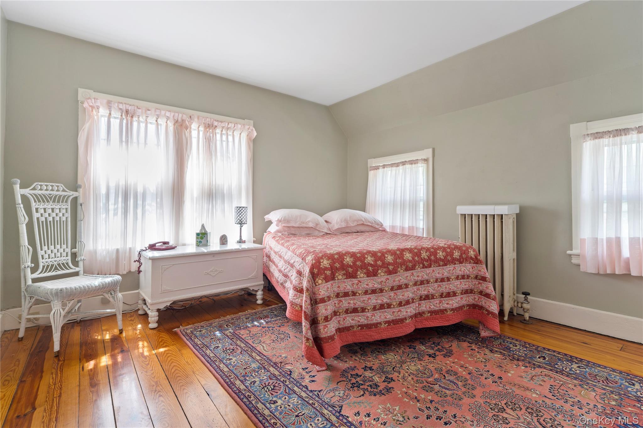 26 Chatham Street Kinderhook, NY 12106 - Photo 12 of 18 a bedroom with a bed and a large window with wooden floor