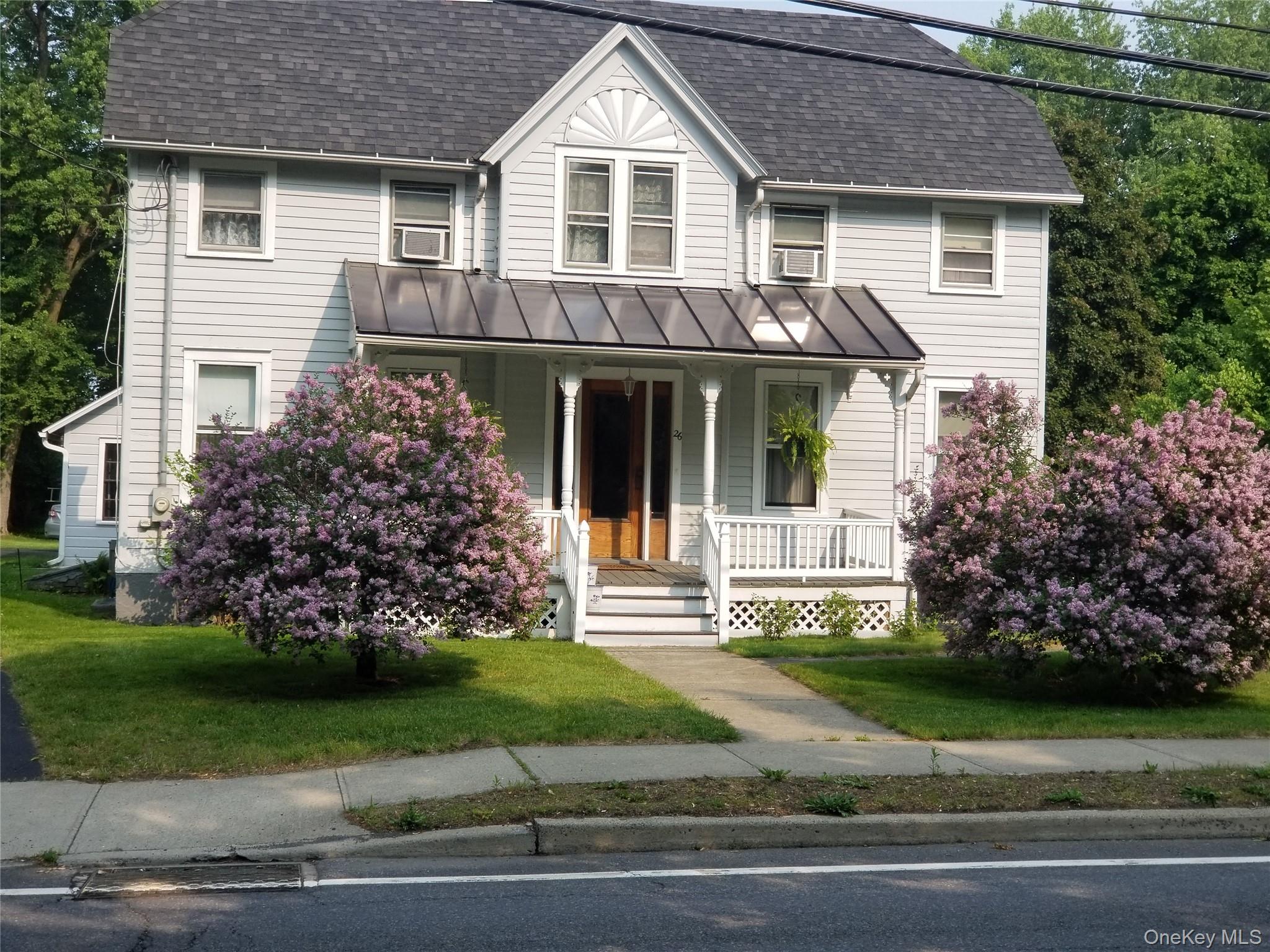 26 Chatham Street Kinderhook, NY 12106 - Photo 14 of 18 a front view of a house with a garden and plants