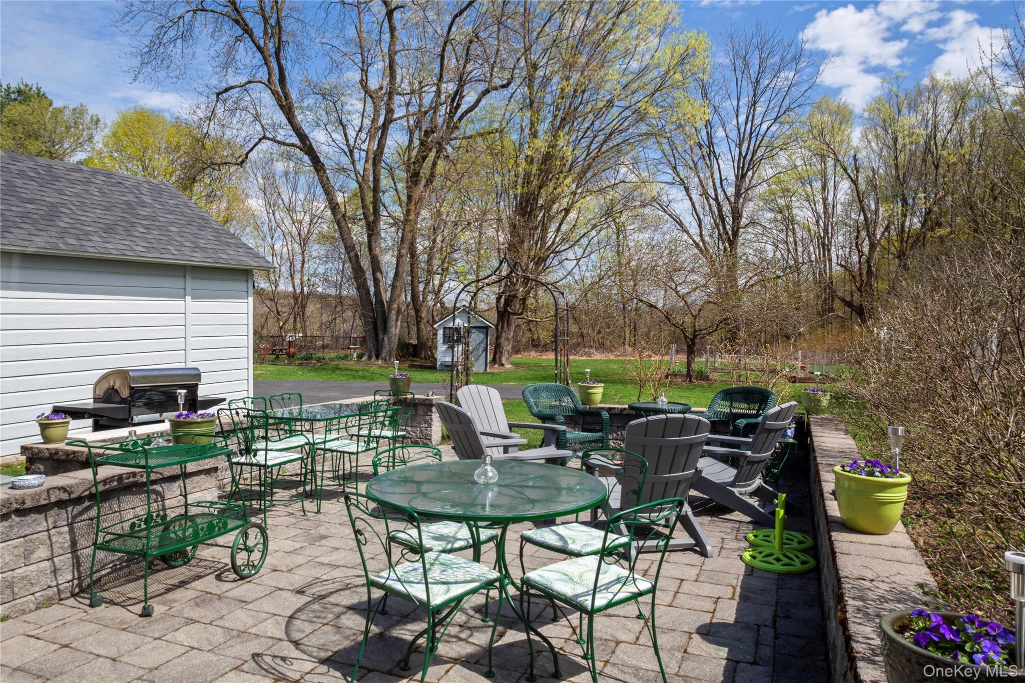 26 Chatham Street Kinderhook, NY 12106 - Photo 3 of 18 a view of backyard with seating space and trees in the background