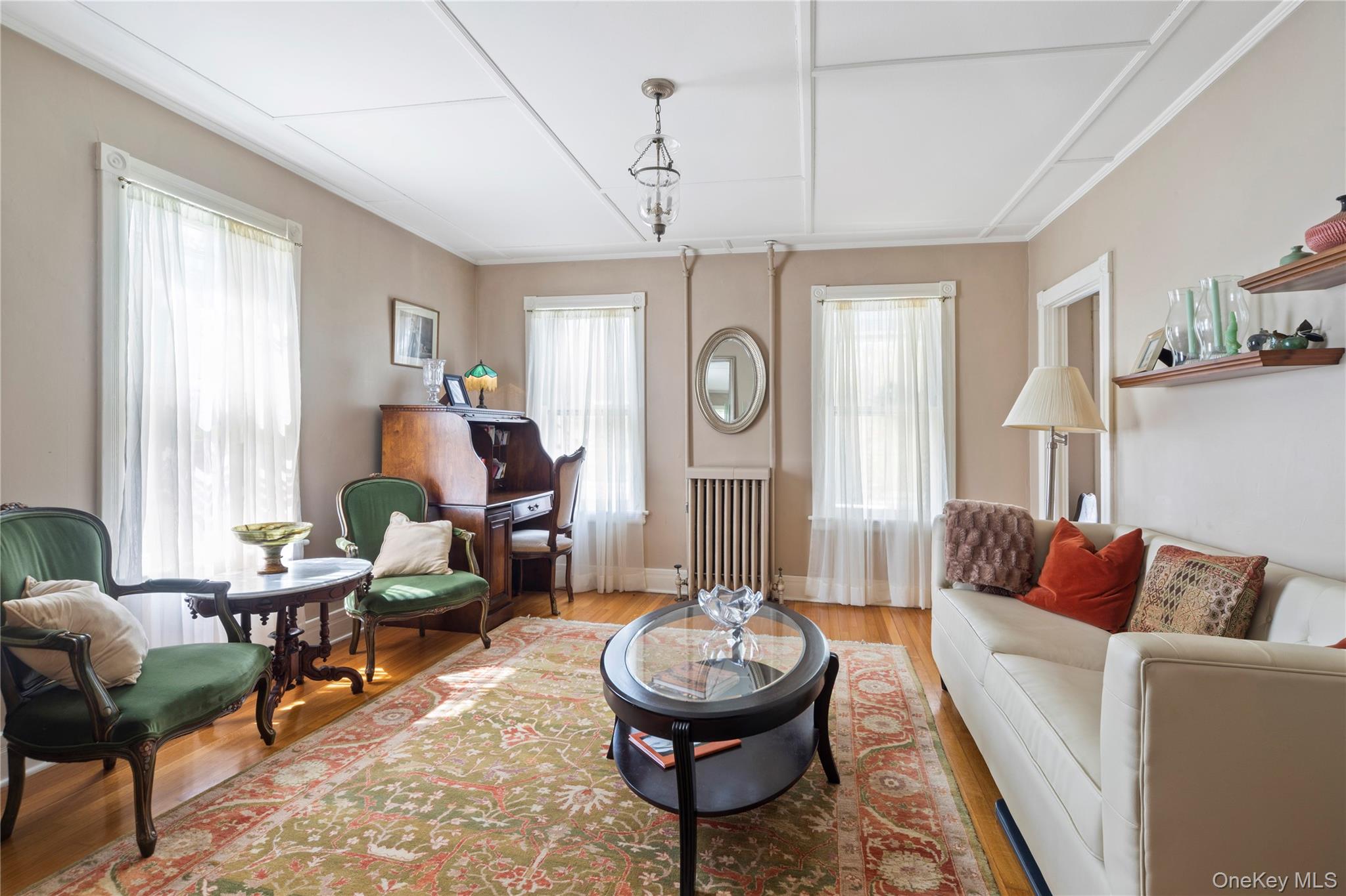 26 Chatham Street Kinderhook, NY 12106 - Photo 6 of 18 a living room with furniture a clock and a window