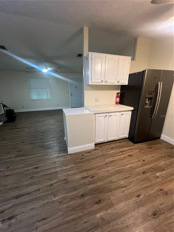 2833 Southeast 18th Terrace Okeechobee, FL 34974 - Photo 17 of 34 a view of a kitchen with wooden floor and electronic appliances