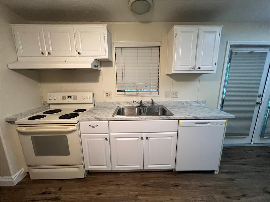 2833 Southeast 18th Terrace Okeechobee, FL 34974 - Photo 19 of 34 a kitchen with white cabinets and white appliances