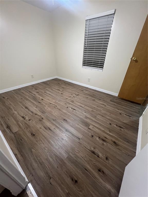 2833 Southeast 18th Terrace Okeechobee, FL 34974 - Photo 29 of 34 a view of an empty room with wooden floor and a window