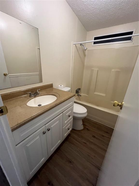 2833 Southeast 18th Terrace Okeechobee, FL 34974 - Photo 33 of 34 a bathroom with a granite countertop sink toilet a mirror and shower