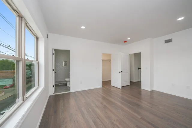 a big room with wooden floor and windows