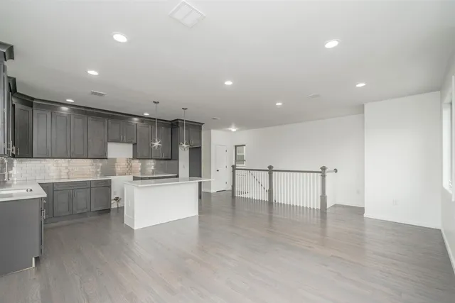 a view of kitchen with cabinets stainless steel appliances with wooden floor
