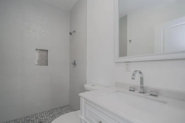 a bathroom with a sink toilet and vanity