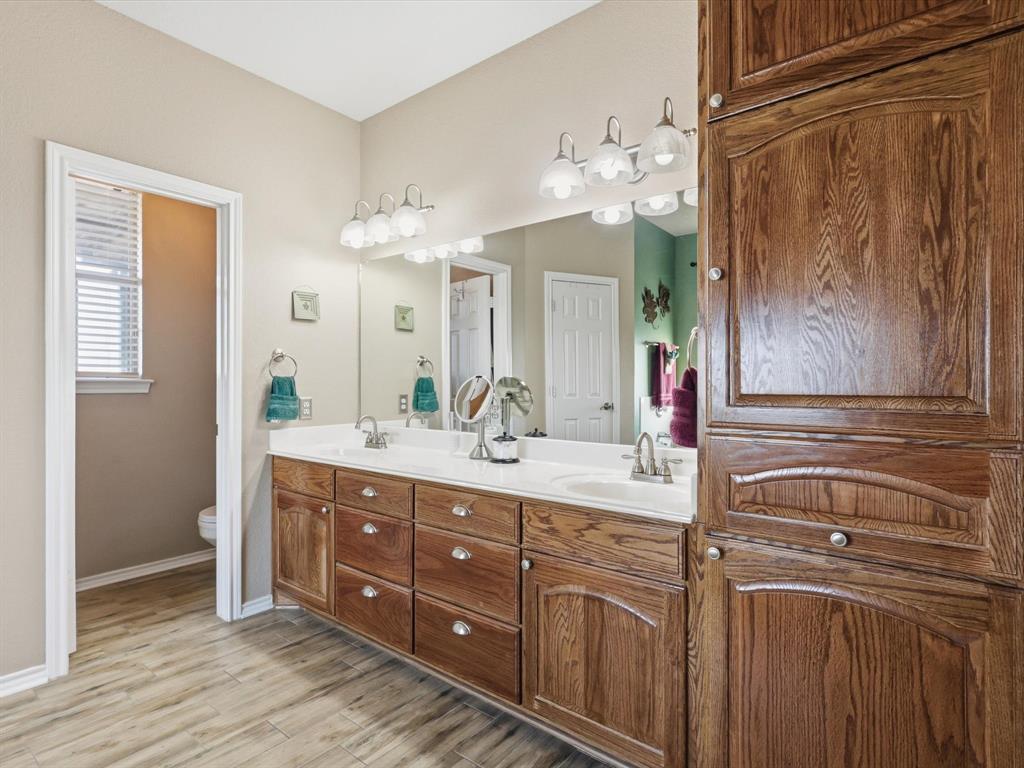 783 Christy Kay Lane Rhome, TX 76078 - Photo 14 of 31 a spacious bathroom with a double vanity sink and a mirror