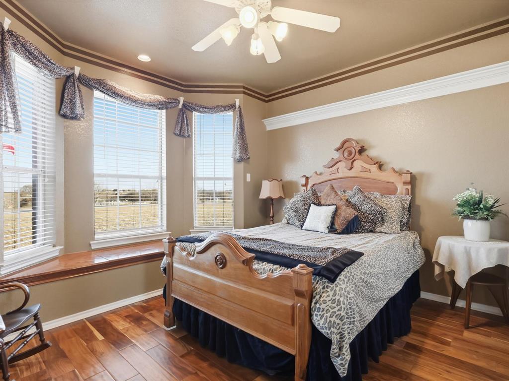 783 Christy Kay Lane Rhome, TX 76078 - Photo 17 of 31 a bedroom with a bed and a chandelier