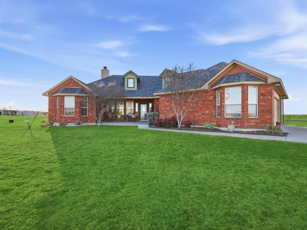 783 Christy Kay Lane Rhome, TX 76078 - Photo 3 of 31 a front view of a house with a yard and potted plants