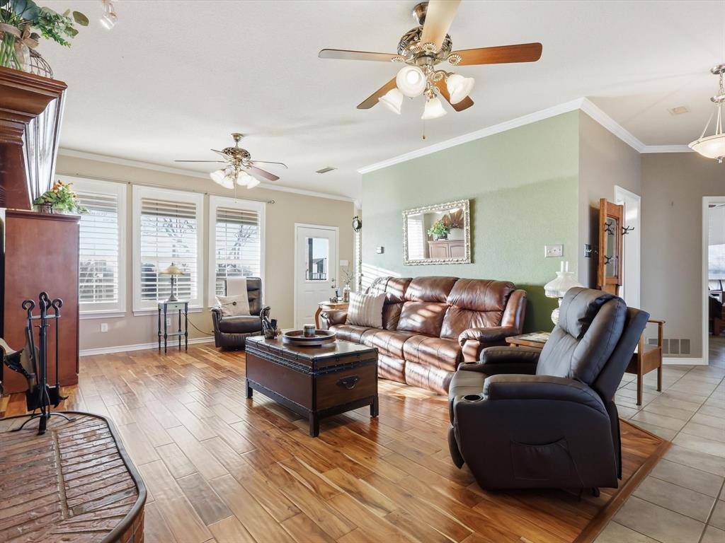 783 Christy Kay Lane Rhome, TX 76078 - Photo 6 of 31 a living room with furniture a fireplace and a chandelier