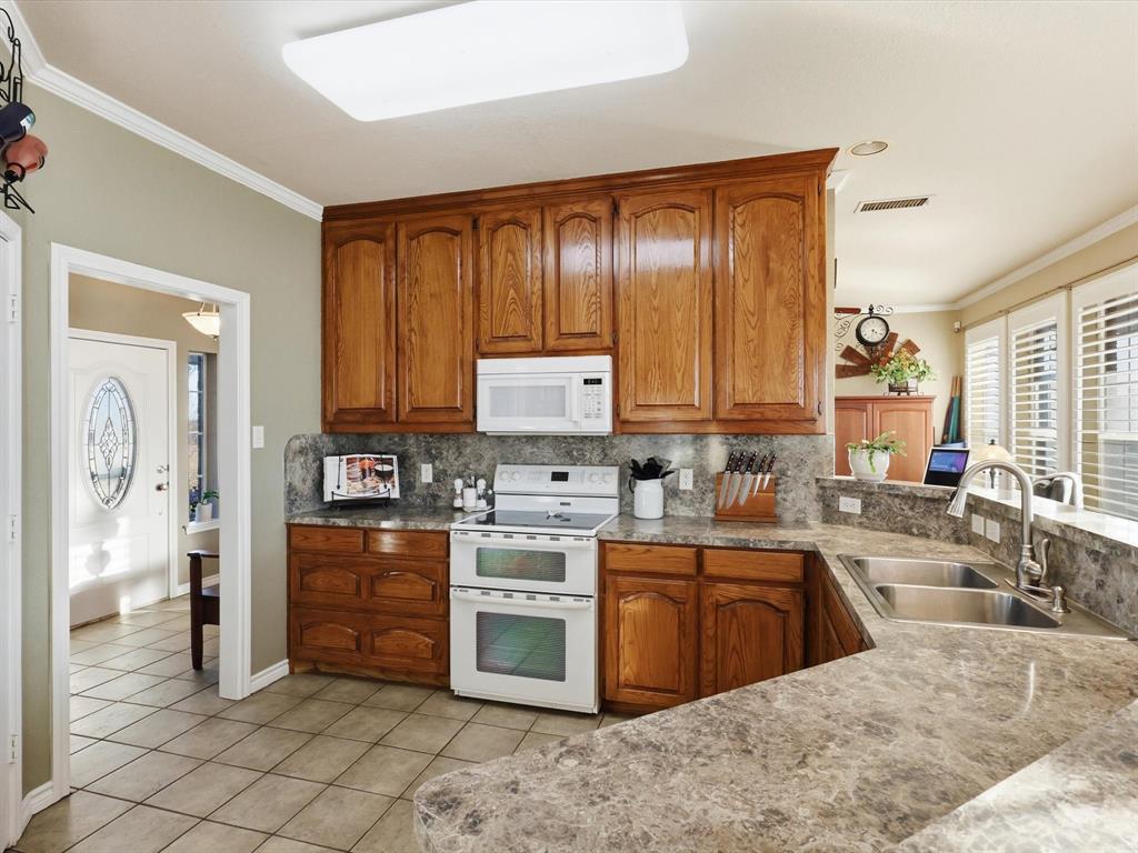 783 Christy Kay Lane Rhome, TX 76078 - Photo 10 of 31 a kitchen with stainless steel appliances granite countertop a stove sink and cabinets