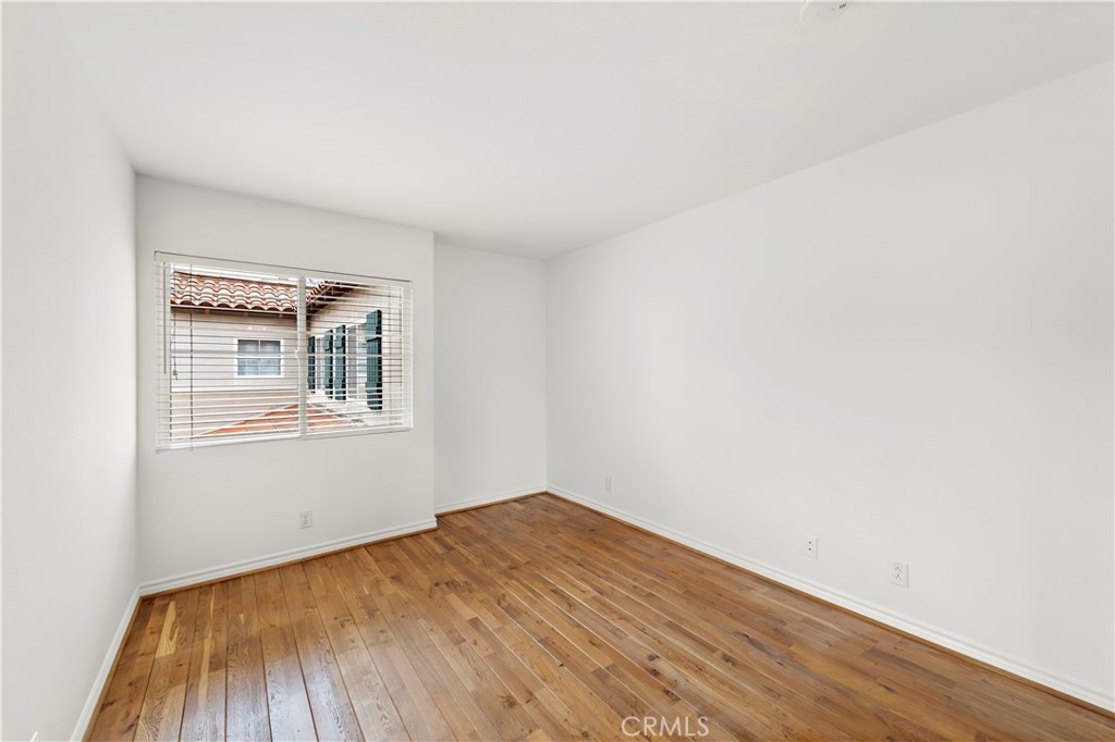 Undisclosed Address Newport Coast, CA 92657 - Photo 13 of 26 an empty room with wooden floor and windows