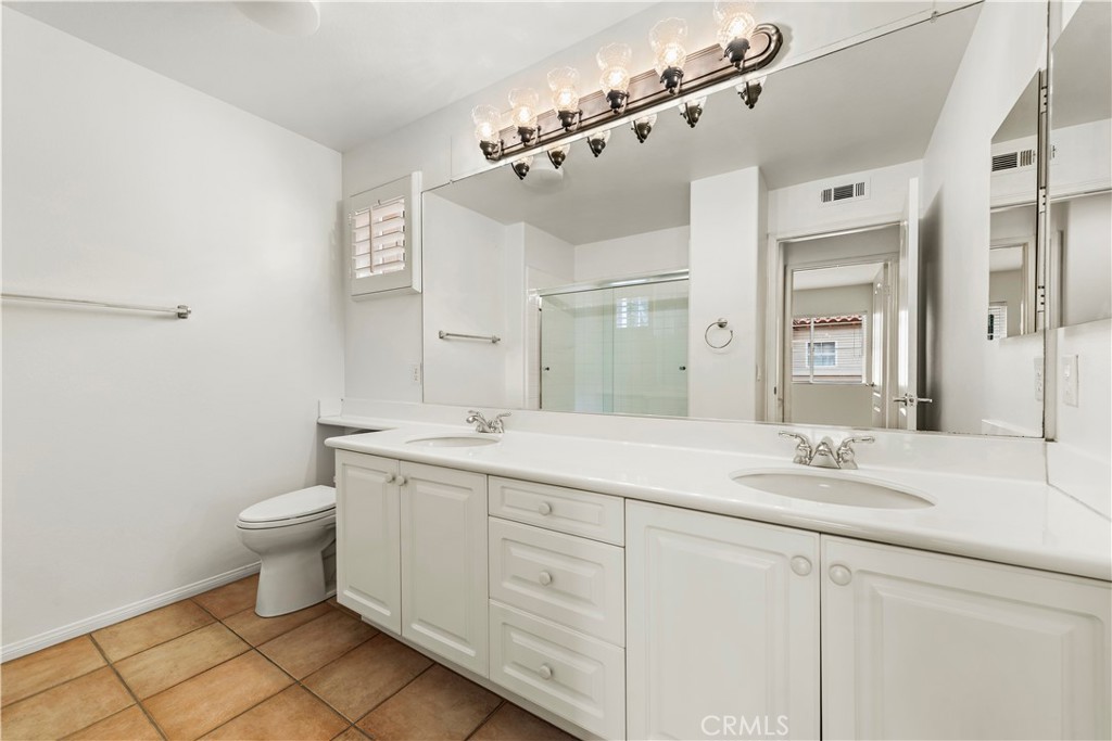 Undisclosed Address Newport Coast, CA 92657 - Photo 14 of 26 a bathroom with a double vanity sink mirror and toilet