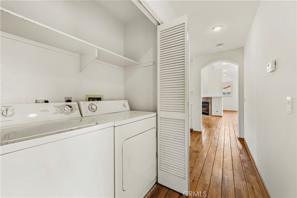 Undisclosed Address Newport Coast, CA 92657 - Photo 16 of 26 a hallway with a sink and wooden floor