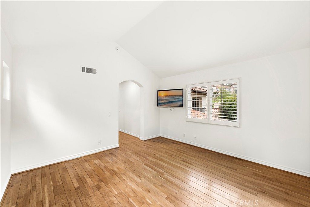 Undisclosed Address Newport Coast, CA 92657 - Photo 17 of 26 an empty room with wooden floor and windows