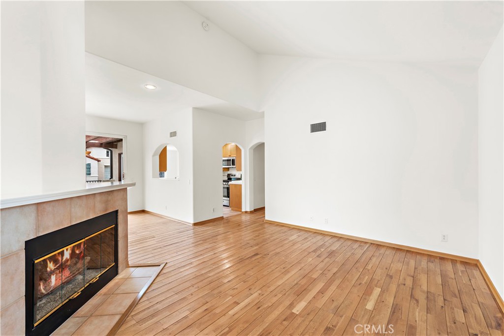 Undisclosed Address Newport Coast, CA 92657 - Photo 4 of 26 a view of an empty room with window and fire place