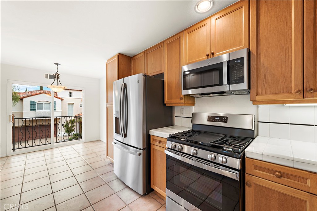 Undisclosed Address Newport Coast, CA 92657 - Photo 9 of 26 a kitchen with stainless steel appliances granite countertop a refrigerator stove and microwave