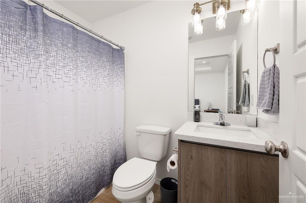 1527 West B Street Mission, TX 78572 - Photo 11 of 17 a bathroom with a sink a toilet and a mirror