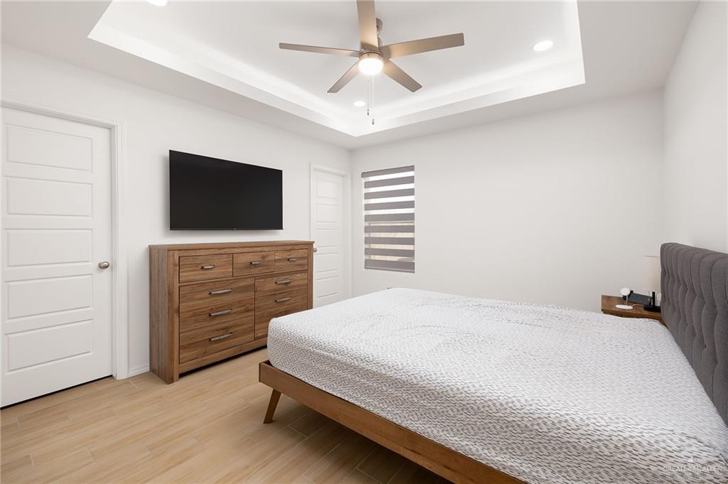 1527 West B Street Mission, TX 78572 - Photo 17 of 17 a bedroom with a bed and a flat screen tv