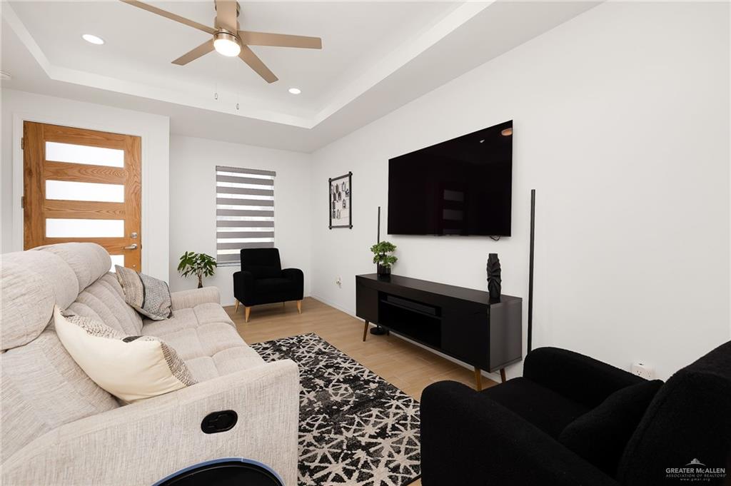 1527 West B Street Mission, TX 78572 - Photo 2 of 17 a living room with furniture and a flat screen tv