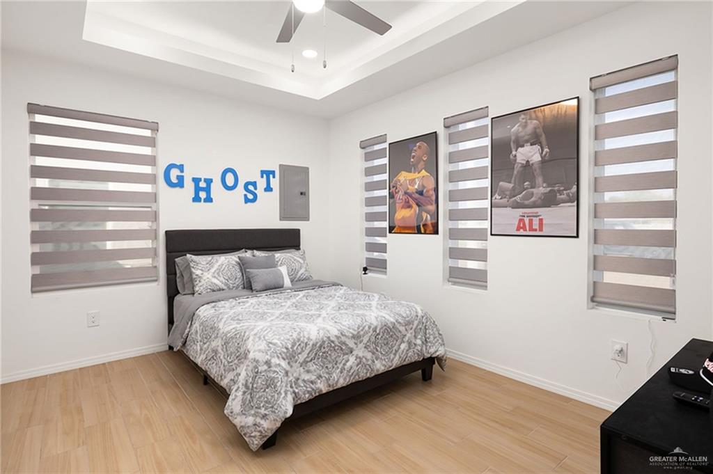 1527 West B Street Mission, TX 78572 - Photo 8 of 17 a bedroom with a bed painting on wall and a window