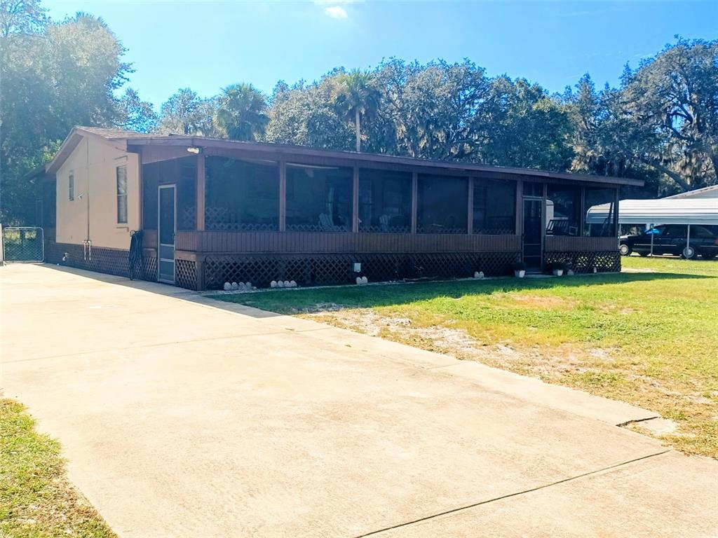 11 Sycamore Street Flagler Beach, FL 32136 - Photo 3 of 21 a view of a house with a yard and sitting area