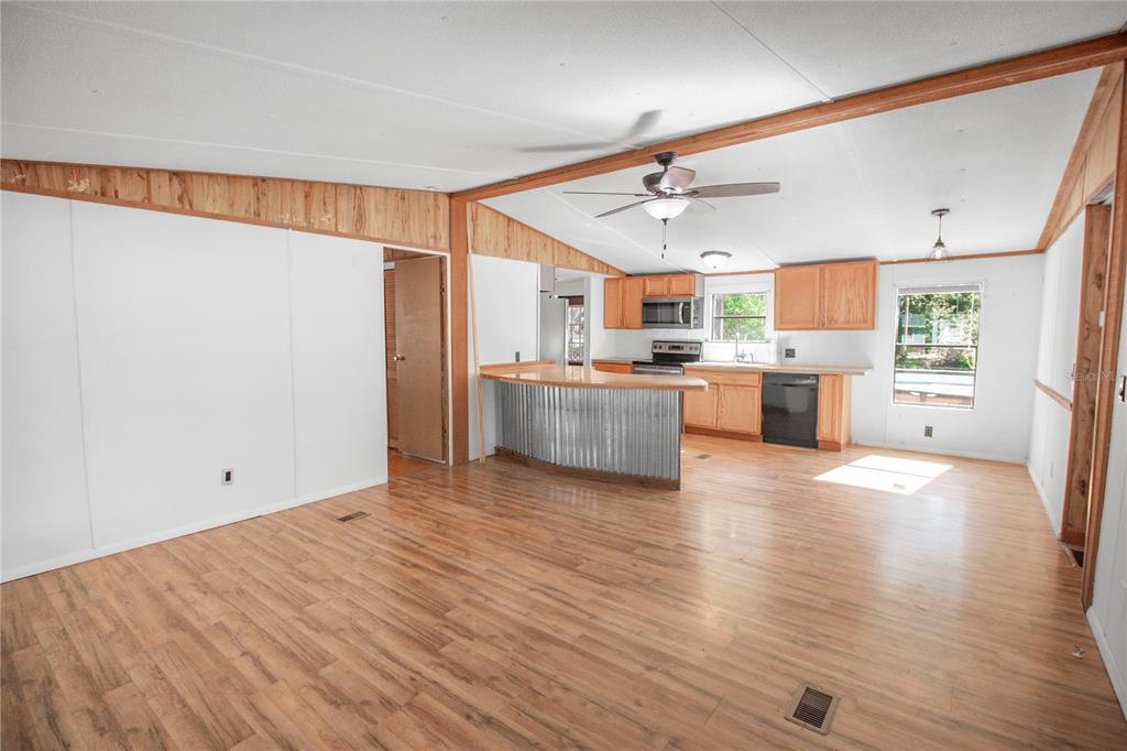 11 Sycamore Street Flagler Beach, FL 32136 - Photo 6 of 21 a view of a kitchen with a sink and a refrigerator