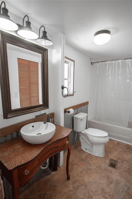 11 Sycamore Street Flagler Beach, FL 32136 - Photo 10 of 21 a bathroom with a sink a toilet and mirror