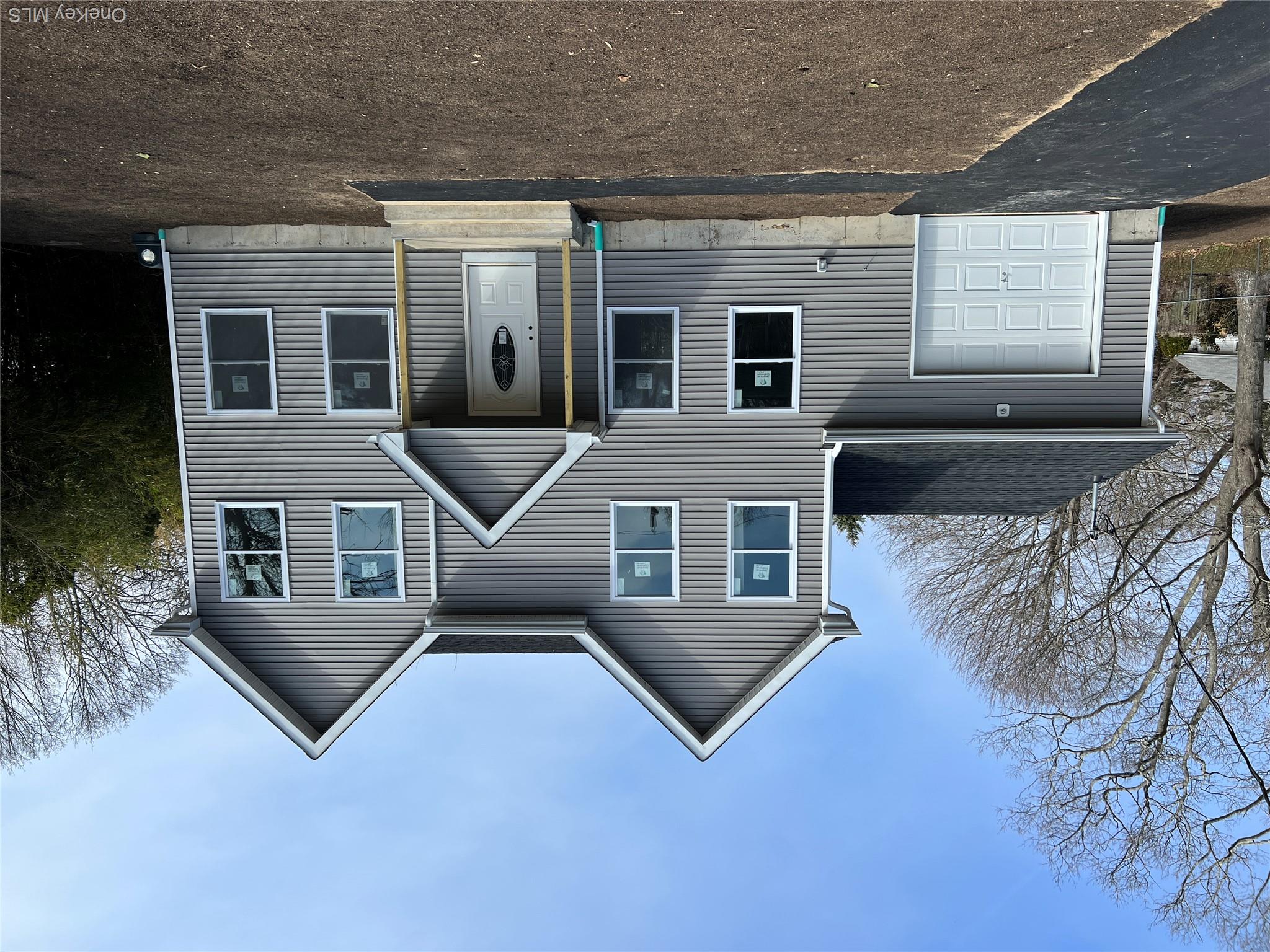 35 Babylon Road Mastic Beach, NY 11951 - Photo 1 of 19 a front view of a house with a garage