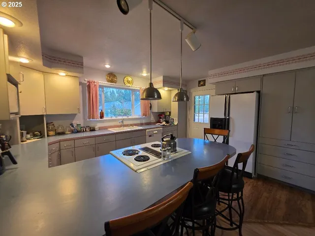 a view of a kitchen with dining area a sink and furniture