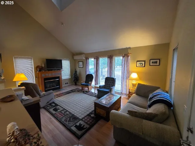 a living room with furniture a ceiling fan and a rug