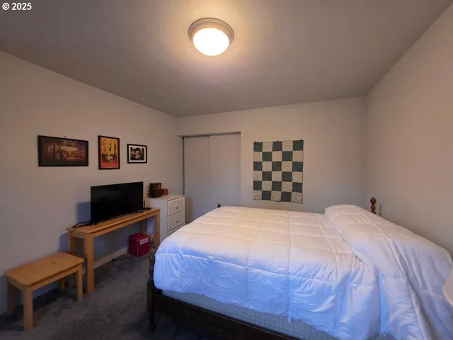 a bedroom with a bed and chair